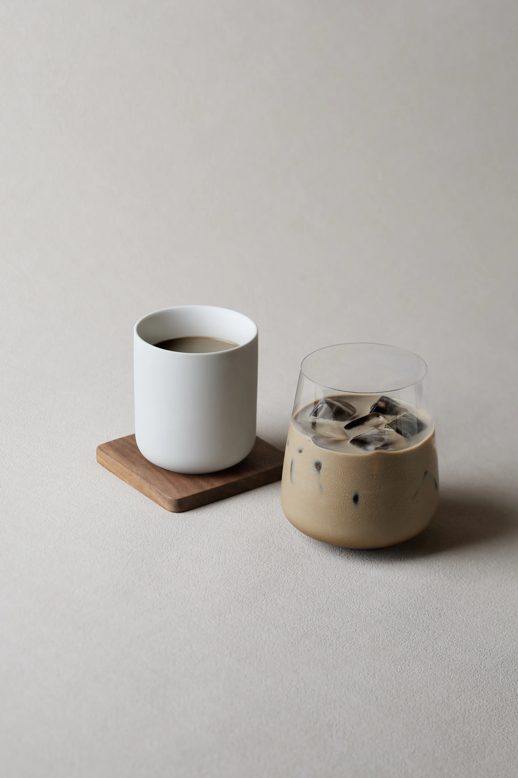 A matcha latte and a bowl of thin-whisked usucha side by side